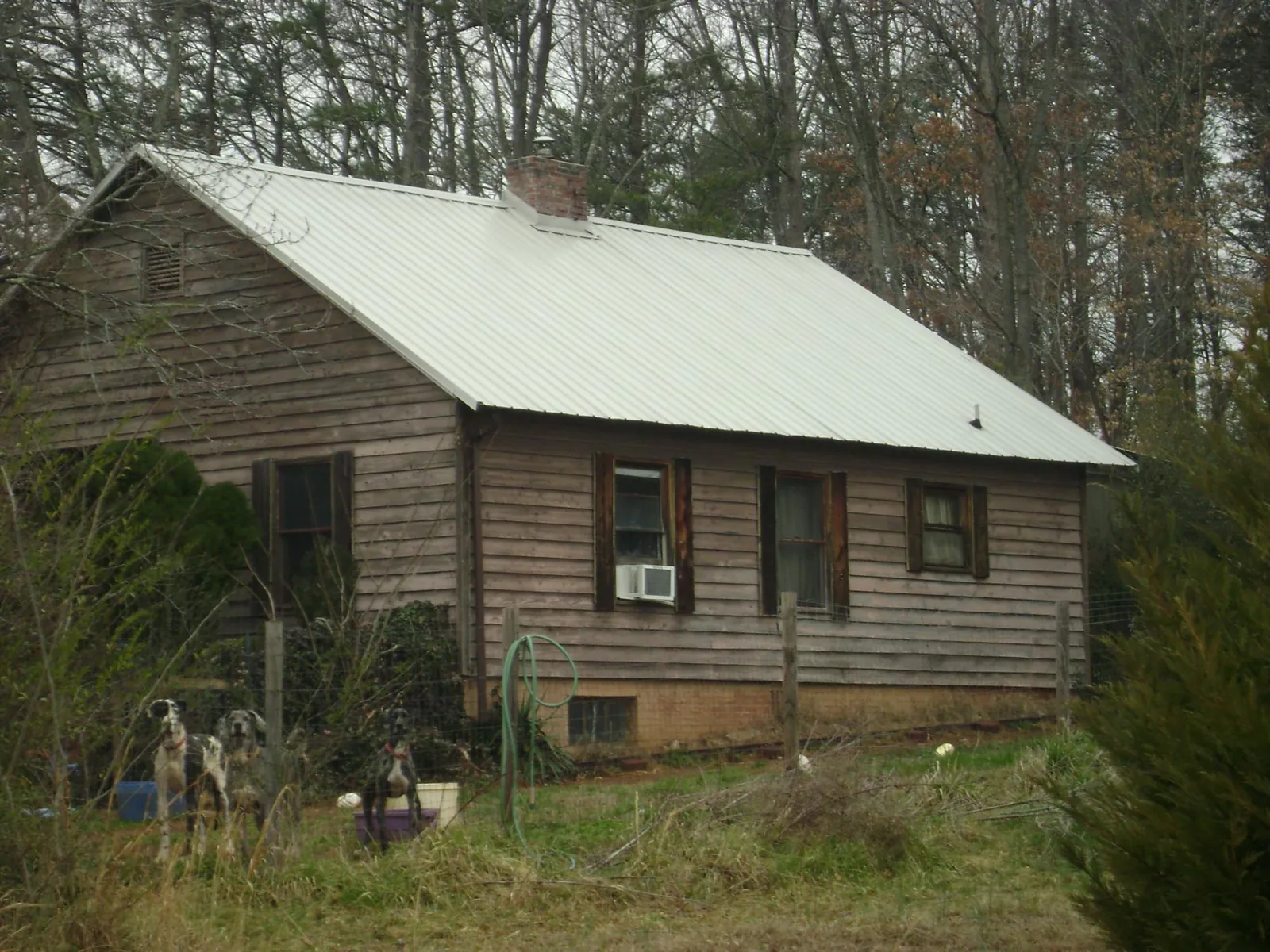 White metal roof on an old wood sided farmhouse, from a Metal Roof Installation job in Kensington